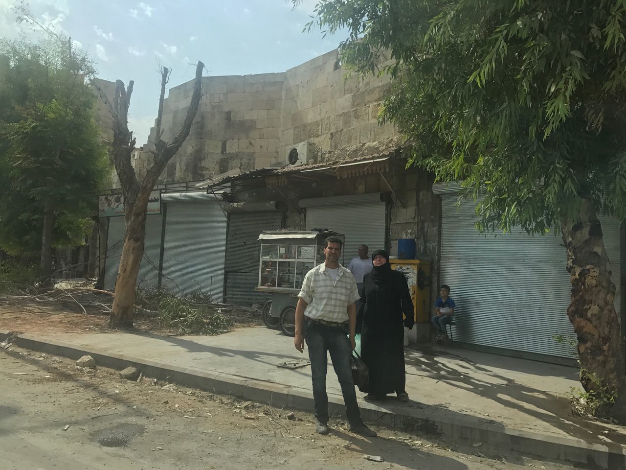 REAR VIEW OF PEOPLE STANDING ON BUILDING