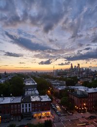 View of cityscape against cloudy sky