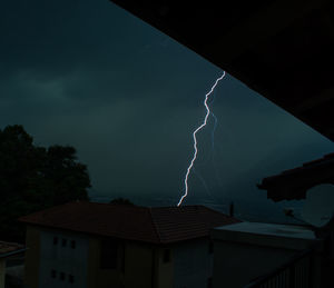 Storm clouds over buildings at night