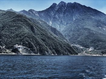 Scenic view of sea and mountains against sky