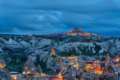 Aerial view of illuminated buildings against sky during winter