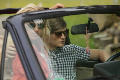 Young couple traveling in car