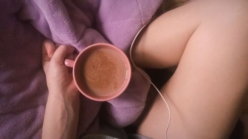 Midsection of woman holding coffee cup