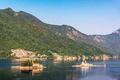 Scenic view of lake and mountains against clear sky