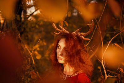 Portrait of young woman looking away outdoors