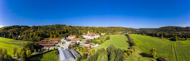 Panoramic view of agricultural field against sky