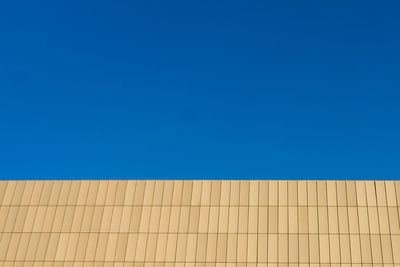 Low angle view of building against clear blue sky