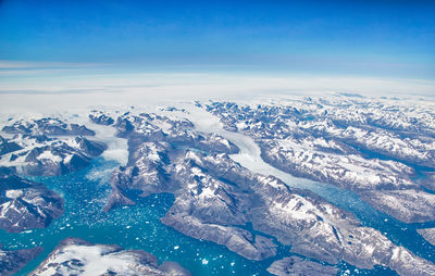 Aerial view of snowcapped mountains against sky