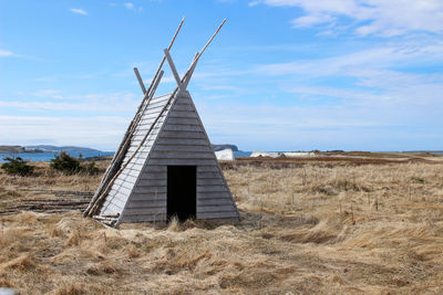 Built structure on field against sky