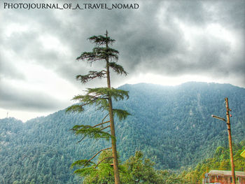 Scenic view of mountains against cloudy sky