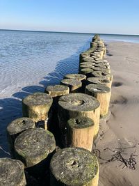 Stack of stones on beach against sky