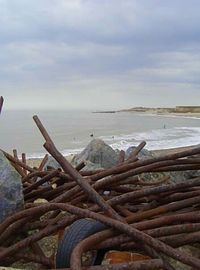 Abandoned container on beach against sky