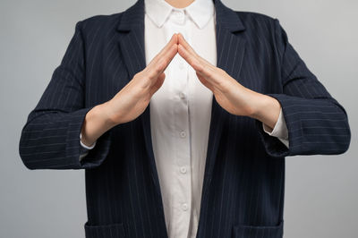 Midsection of man standing against blue background