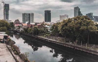 Reflection of trees and buildings in canal