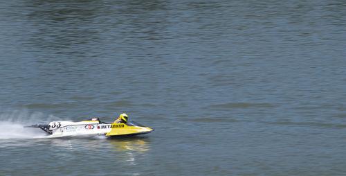 High angle view of men sailing on lake