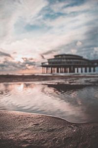 Pier over sea against sky during sunset