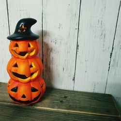 Pumpkin on table against wall during halloween