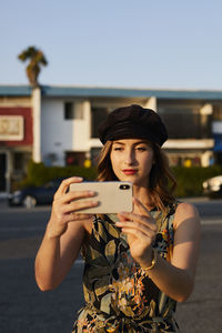 Young woman using mobile phone in city