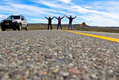 Men on road against sky