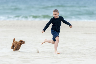 Full length of man running on beach