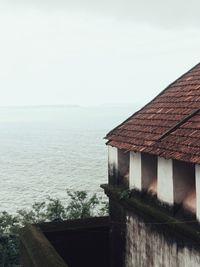 House by sea against sky