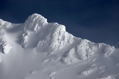 Scenic view of snow covered mountains against sky