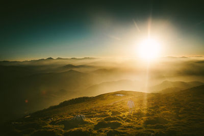 Scenic view of mountain range against sky during sunset