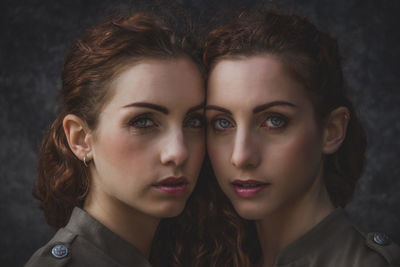 Portrait of siblings against wall