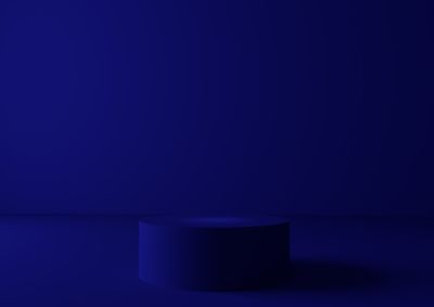 Close-up of illuminated blue wall in darkroom