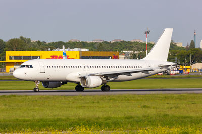 Airplane on airport runway against clear sky