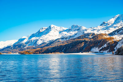 Engadine, switzerland, sils maria lake, the village of isola and the snowy landscape.