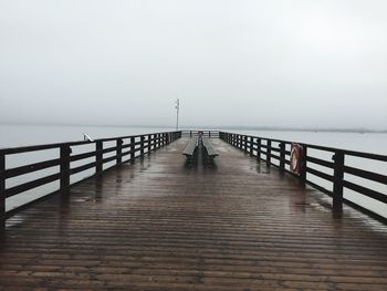 Pier over sea against clear sky