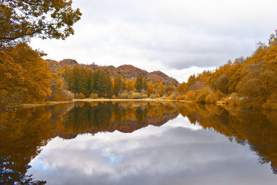 Reflection of trees in lake against sky during autumn