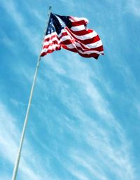 Low angle view of american flag against sky