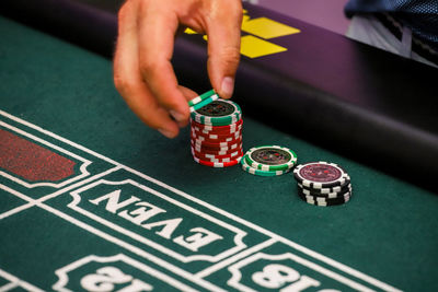 Close-up of hands playing piano on table