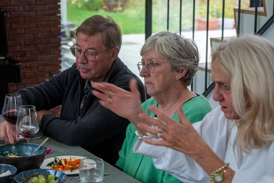 Portrait of smiling friends having food at restaurant