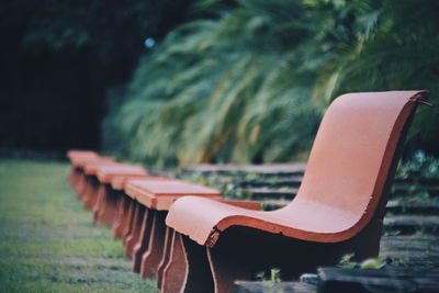 Close-up of empty bench in park