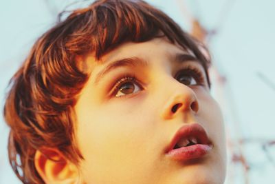 Close-up portrait of cute girl looking away