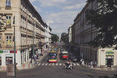 People and vehicles on street in city