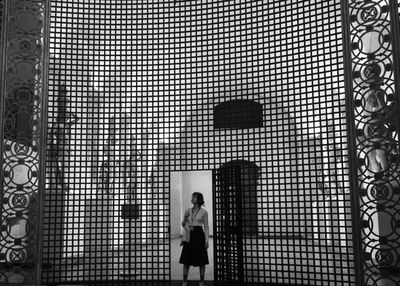 Woman standing at entrance of building