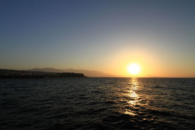 Scenic view of sea against clear sky during sunset