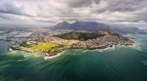 Aerial view of sea against cloudy sky