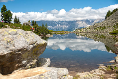 Scenic view of lake and mountains against sky