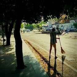 Full length of woman standing on tree trunk