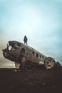 Abandoned airplane on runway against sky