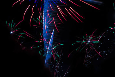 Low angle view of firework display at night