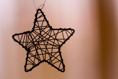 Close-up of star shape decoration against wall