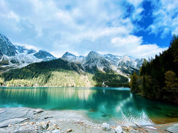 Scenic view of lake and mountains against sky