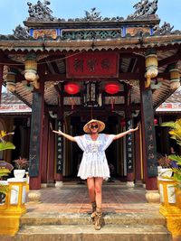 Full length portrait of woman standing at temple