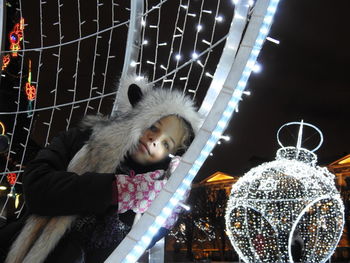 Girl looking at illuminated camera